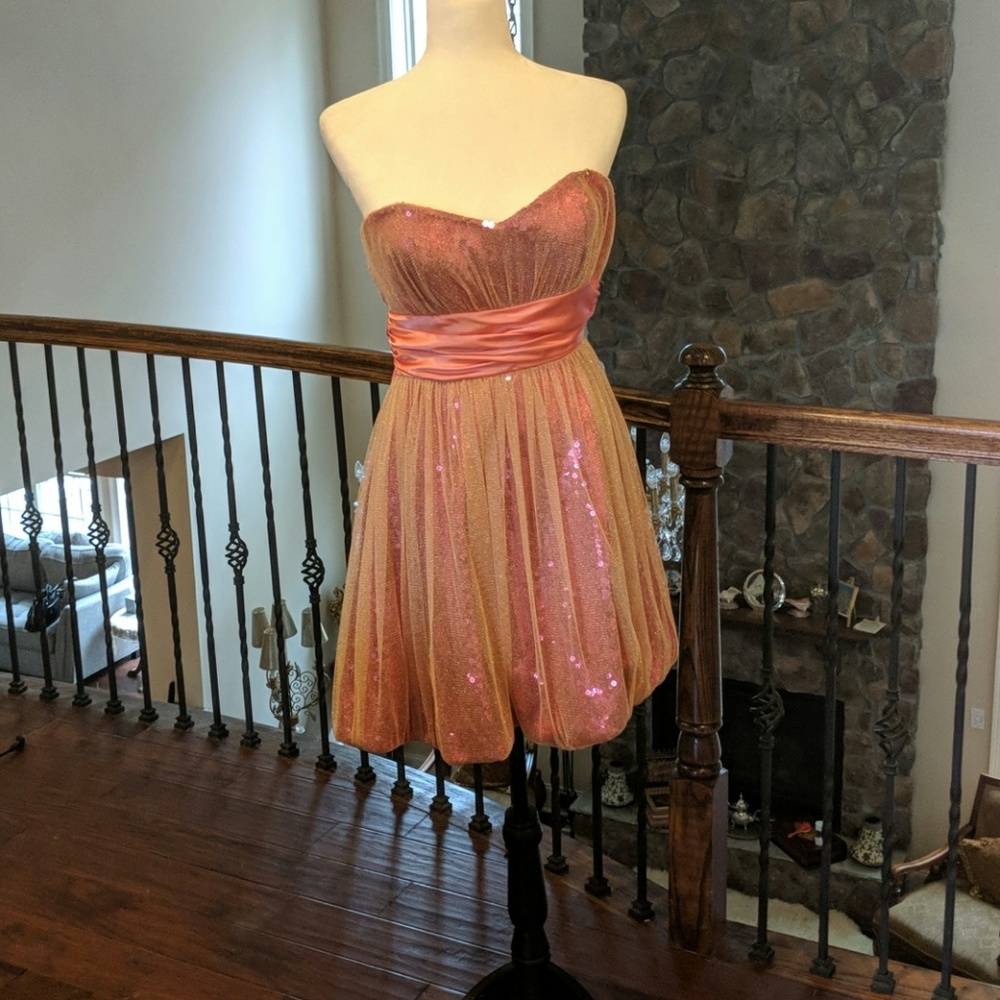 A pink short shimmery prom dress in a size 6